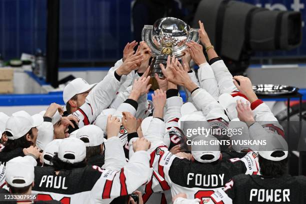 Canada's players celebrate with the trophy after winning the IIHF Men's Ice Hockey World Championships final match between the Finland and Canada at...