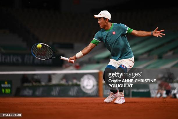 Japan's Kei Nishikori returns the ball to Germany's Alexander Zverev during their men's singles fourth round tennis match on Day 8 of The Roland...