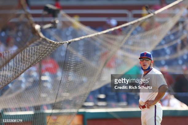 Manager Joe Girardi of the Philadelphia Phillies looks on after the protective netting from home plate to first base collapsed during the eighth...
