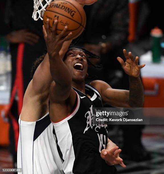 Terance Mann of the Los Angeles Clippers scores a baskets and gets fouled by Dwight Powell of the Dallas Mavericks during the first half of Game...