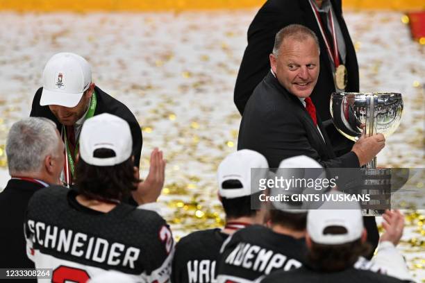 Canada's head coach Gerard Gallant holds the trophy after his team won the IIHF Men's Ice Hockey World Championships final match between the Finland...