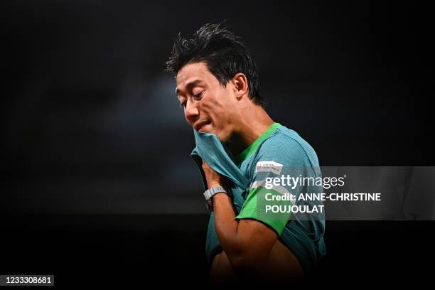 Japan's Kei Nishikori reacts as he plays against Germany's Alexander Zverev during their men's singles fourth round tennis match on Day 8 of The...