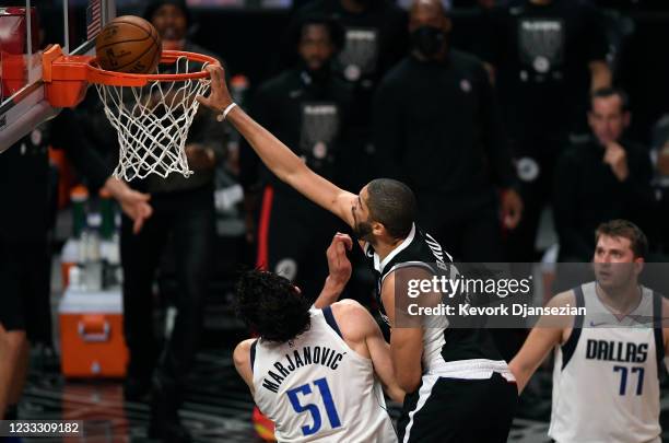Nicolas Batum of the Los Angeles Clippers dunks the ball against Boban Marjanovic of the Dallas Mavericks during the first half of Game Seven of the...