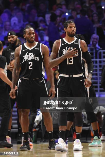 Kawhi Leonard of the LA Clippers and Paul George of the LA Clippers look on during Round 1, Game 7 of the 2021 NBA Playoffs on June 6, 2021 at...