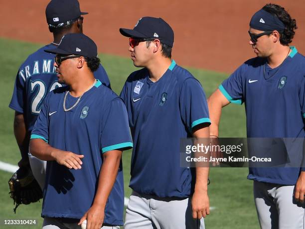 Yusei Kikuchi of the Seattle Mariners shakes hands with players after the game defeating the Los Angeles Angels at Angel Stadium of Anaheim on June...