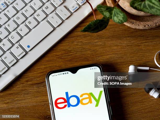 In this photo illustration an eBay logo seen displayed on a smartphone.