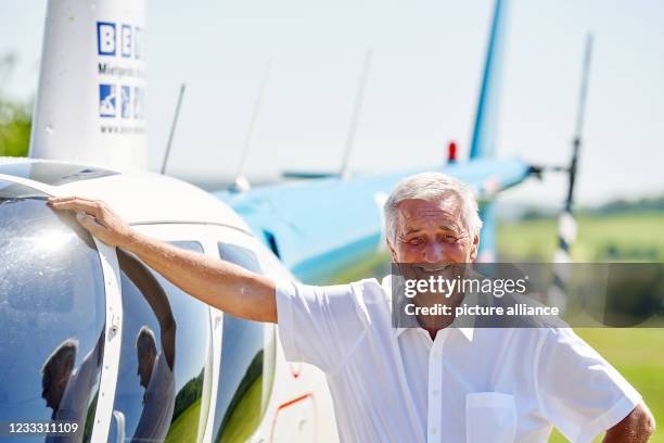 June 2021, Rhineland-Palatinate, Kroppach: Entrepreneur, globetrotter and foundation founder Reiner Meutsch stands in front of his helicopter. In...