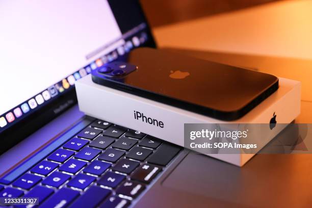 In this photo illustration, Apples iPhone 12 seen placed on a MacBook Pro.