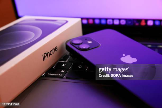 In this photo illustration, Apples iPhone 12 seen placed on a MacBook Pro.