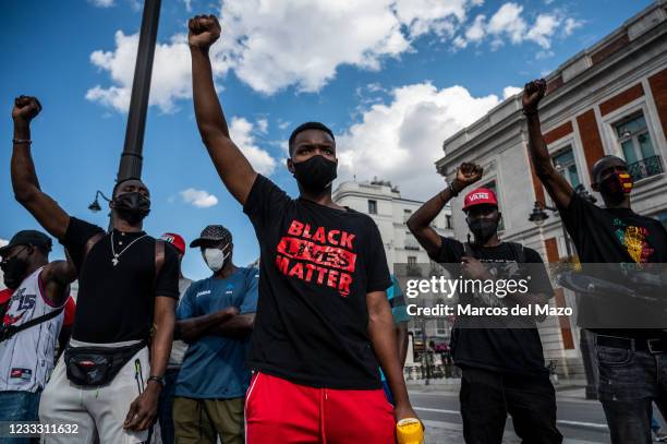 People raising their fists during a protest against racism as part of the Black Lives Matter social movement related with the death of the...