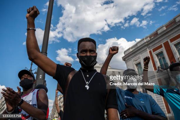 People raising their fists during a protest against racism as part of the Black Lives Matter social movement related with the death of the...