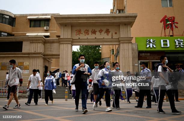 Students leave a school after finishing the first day of the National College Entrance Examination , known as Gaokao, in Beijing on July 7, 2021.