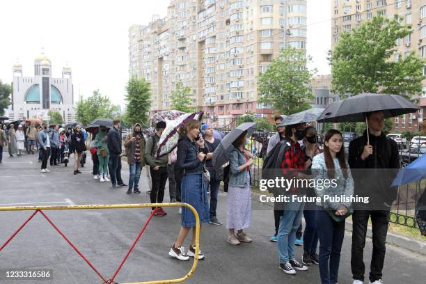 People queue at the COVID-19 vaccination centre set up at the International Exhibition Centre , Kyiv, capital of Ukraine.