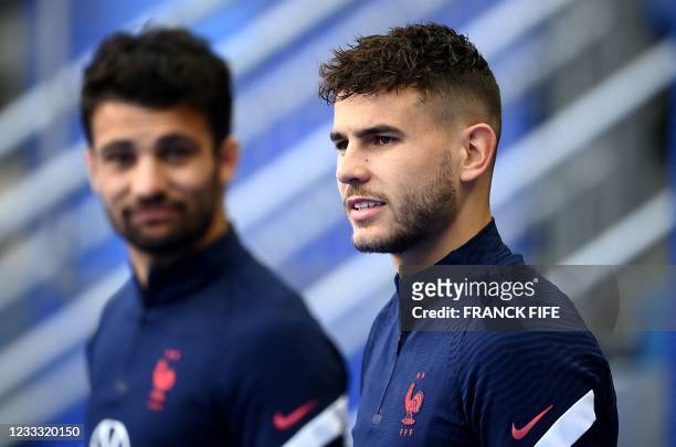 France's defender Leo Dubois and France's defender Lucas Hernandez arrive for a training session at the Stade de France in Saint-Denis, north of...