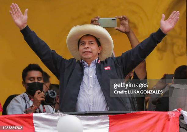 Peruvian presidential candidate Pedro Castillo gestures at supporters from a balcony of his party's headquarters in Lima on June 7 after taking a...