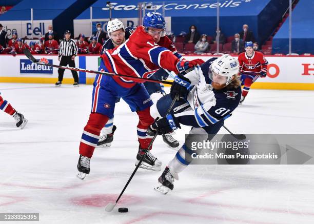 Nick Suzuki of the Montreal Canadiens pushes Kyle Connor of the Winnipeg Jets during the second period in Game Four of the Second Round of the 2021...