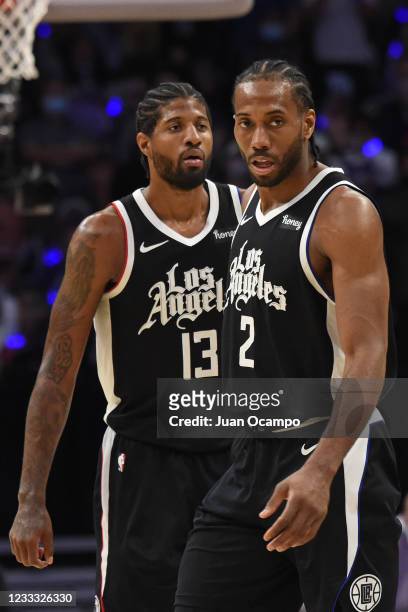 Kawhi Leonard of the LA Clippers and Paul George of the LA Clippers look on during Round 1, Game 5 of the 2021 NBA Playoffs on June 2, 2021 at...