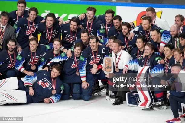 The United States' players celebrate during the awarding ceremony after the bronze medal game between the United States and Germany at the 2021 IIHF...
