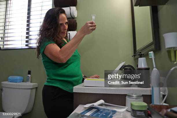 Kathryn Holcomb-Kirby gives a saliva sample for Ancestry.com testing, at her home in Margate, Fla. Maryland is becoming one of the first states in...