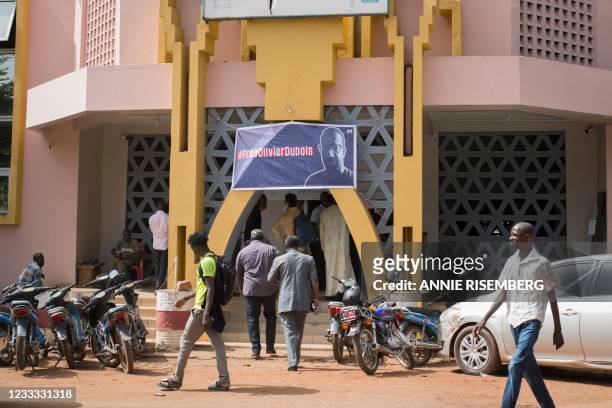 Poster with #FreeOlivierDubois written on it hangs in-front of The Maison de la Presse in Bamako on June 8 ahead of an event in support of the French...