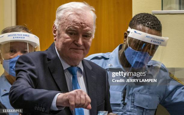 Ex-Bosnian Serb military chief Ratko Mladic arrives in the courtroom prior to the hearing of the final verdict on appeal against his genocide...