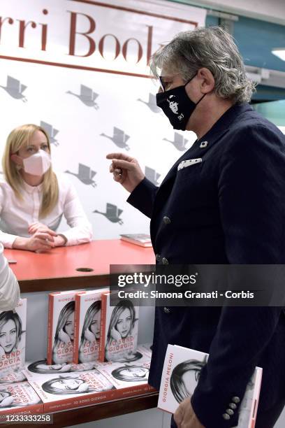 Former footballer Sebastiano Nela gives his book "Il vento in faccia e la tempesta nel cuore" to Giorgia Meloni and jokingly places the two books...