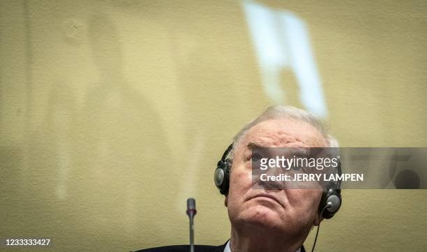 Ex-Bosnian Serb military chief Ratko Mladic sits in the defendant box prior to the hearing of the final verdict on appeal against his genocide...