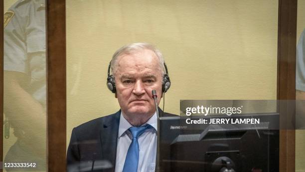 Ex-Bosnian Serb military chief Ratko Mladic sits in the defendant box prior to the hearing of the final verdict on appeal against his genocide...