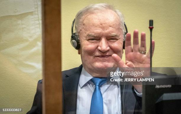 Ex-Bosnian Serb military chief Ratko Mladic smiles from the defendant box prior to the hearing of the final verdict on appeal against his genocide...
