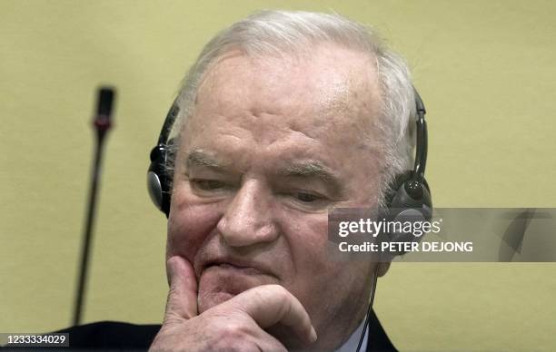 Ex-Bosnian Serb military chief Ratko Mladic looks on from the defendant box prior to the hearing of the final verdict on appeal against his genocide...