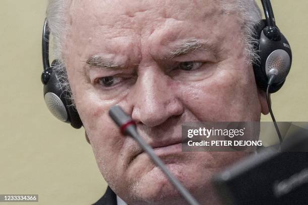 Ex-Bosnian Serb military chief Ratko Mladic looks on from the defendant box during the earing of the final verdict on appeal against his genocide...