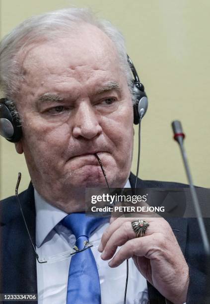Ex-Bosnian Serb military chief Ratko Mladic looks on from the defendant box during the earing of the final verdict on appeal against his genocide...
