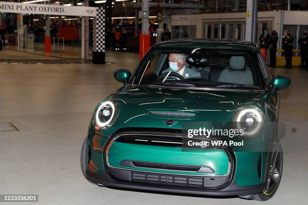 Prince Charles, Prince of Wales drives an electric Mini on a visit to the MINI plant on June 8, 2021 in Oxford, England.
