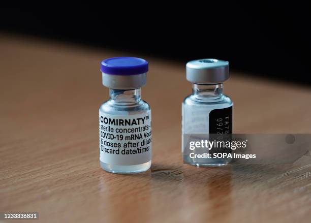 In this photo illustration, Comirnaty COVID-19 vaccine vials seen displayed on a table.