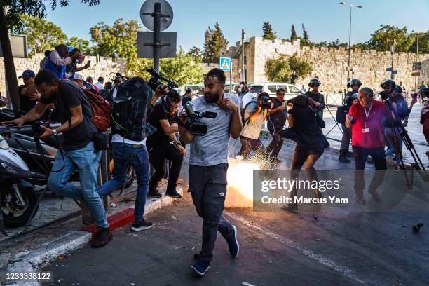 Israeli security forces throw stun grenades at working journalists after a crowd started to gather for a news conference calling for the release of...