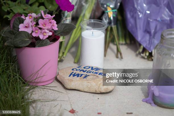 Flowers candles and messages are left at a makeshift memorial on June 8 near the site where a man driving a pickup truck struck and killed four...