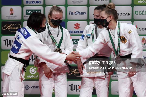 Gold medalist Canada's Jessica Klimkait celebrates on the podium of the awarding ceremony with silver medalist Japan's Momo Tamaoki and bronze...