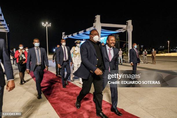 Uhuru Kenyatta , President of Kenya, and Abiy Ahmed, Prime Minister of Ethiopia, walk out after the ceremony for the signing of Ethiopias telecom...