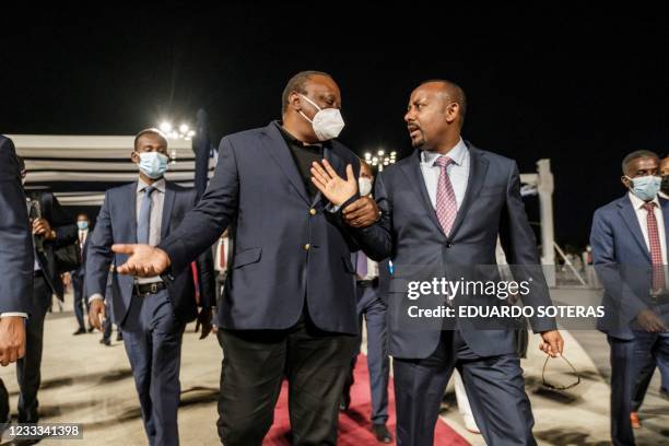 Uhuru Kenyatta , President of Kenya, and Abiy Ahmed, Prime Minister of Ethiopia, talk after the ceremony for the signing of Ethiopias telecom...