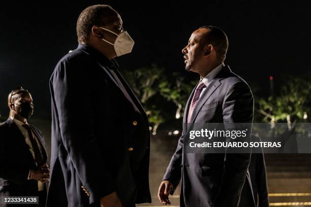 Uhuru Kenyatta , President of Kenya, and Abiy Ahmed, Prime Minister of Ethiopia, talk after the ceremony for the signing of Ethiopias telecom...