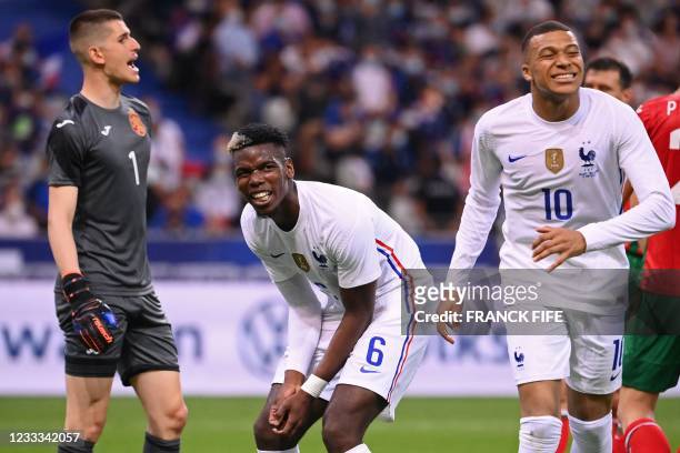 Bulgaria's goalkeeper Daniel Naumov, France's midfielder Paul Pogba and France's forward Kylian Mbappe react during the friendly football match...