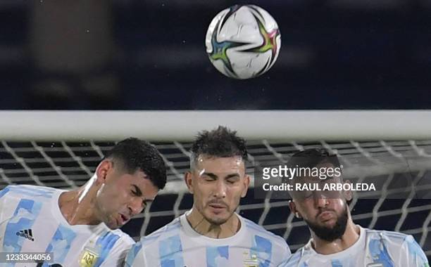 Argentina's Cristian Romero, Argentina's Leandro Paredes and Argentina's Nicolas Gonzalez jump to block the ball during the South American...