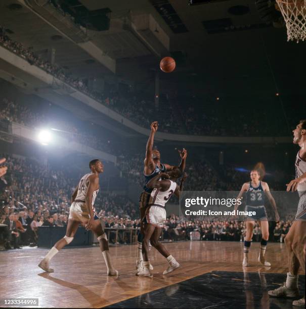 Ed Burton and Al Butler of the New York Knicks play defense against an unidentified player and Jim Krebs of the Los Angeles Lakers at the old Madison...