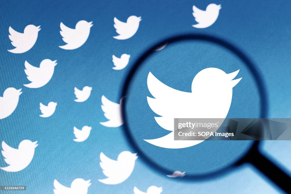 In this photo illustration a Twitter logo is seen on a...
