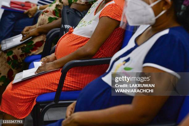 Pregnant women wait to get a dose of the Chinese-made Sinopharm Covid-19 coronavirus vaccine after the government imposed a lockdown with travel...