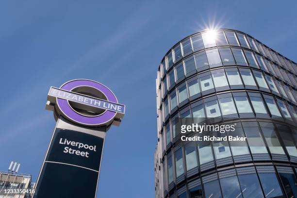 Nearby offices and Crossrail's Elizabeth Line logo at Liverpool Street in the City of London, the capital's financial district, on 8th June 2021, in...