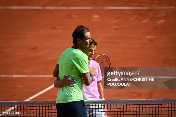 Winner Spain's Rafael Nadal congratlates Argentina's Diego Schwartzman at the end of their men's singles quarter-final tennis match on Day 11 of The...