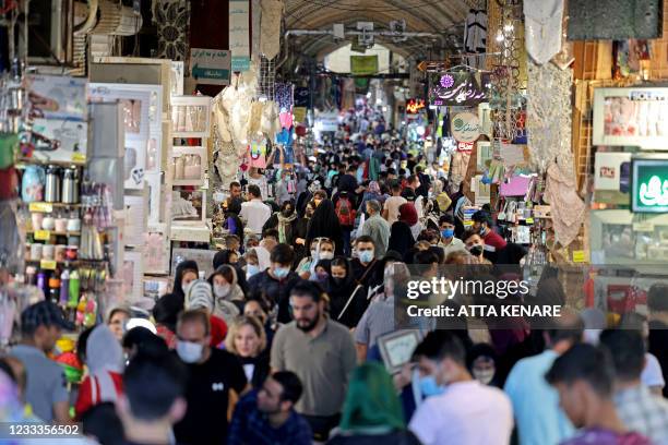 Iranians shop at the Grand Bazaar of Iran's capital Tehran on June 9, 2021. When Iranians vote for a new president next week, they will do so in the...
