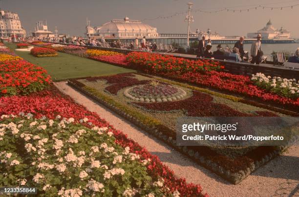 Formal gardens on the seafront at Eastbourne in East Sussex with the Pier beyond, circa July 1990.