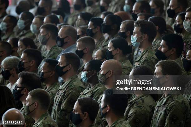 Air Force personnel and their families stationed at Royal Air Force Mildenhall listen to US President Joe Biden's address in Suffolk, England on June...